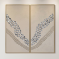 Large-scale abstract diptych art with gold frames hanging over a wooden console table in a modern, bright hotel hallway.