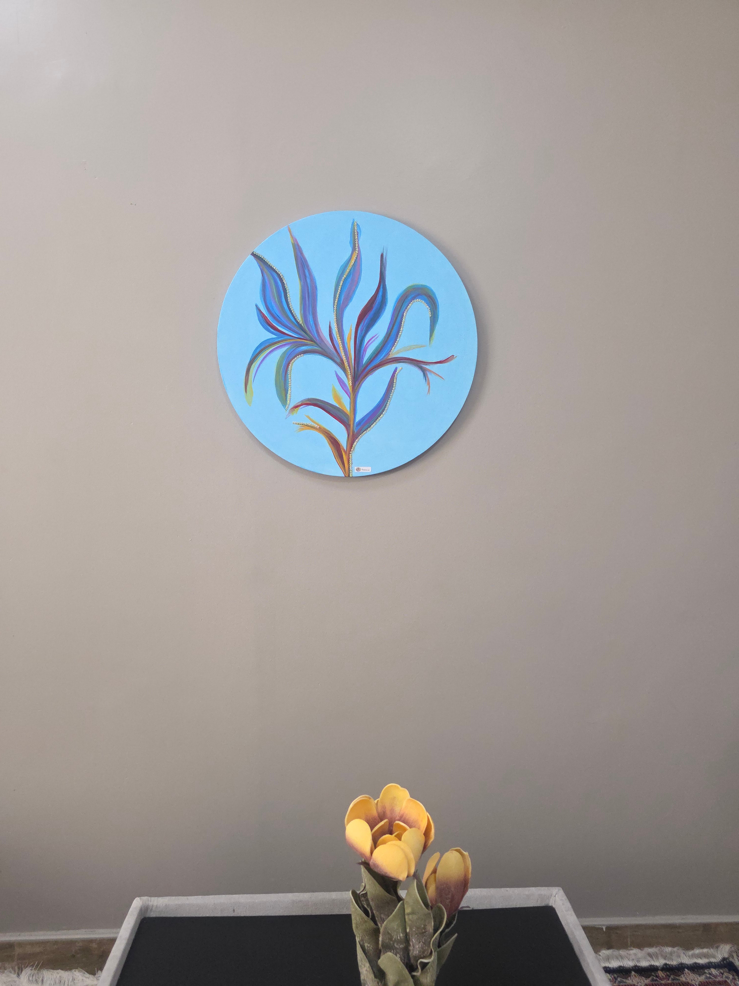 Decorative circular wall art with floral design on a plain wall.
