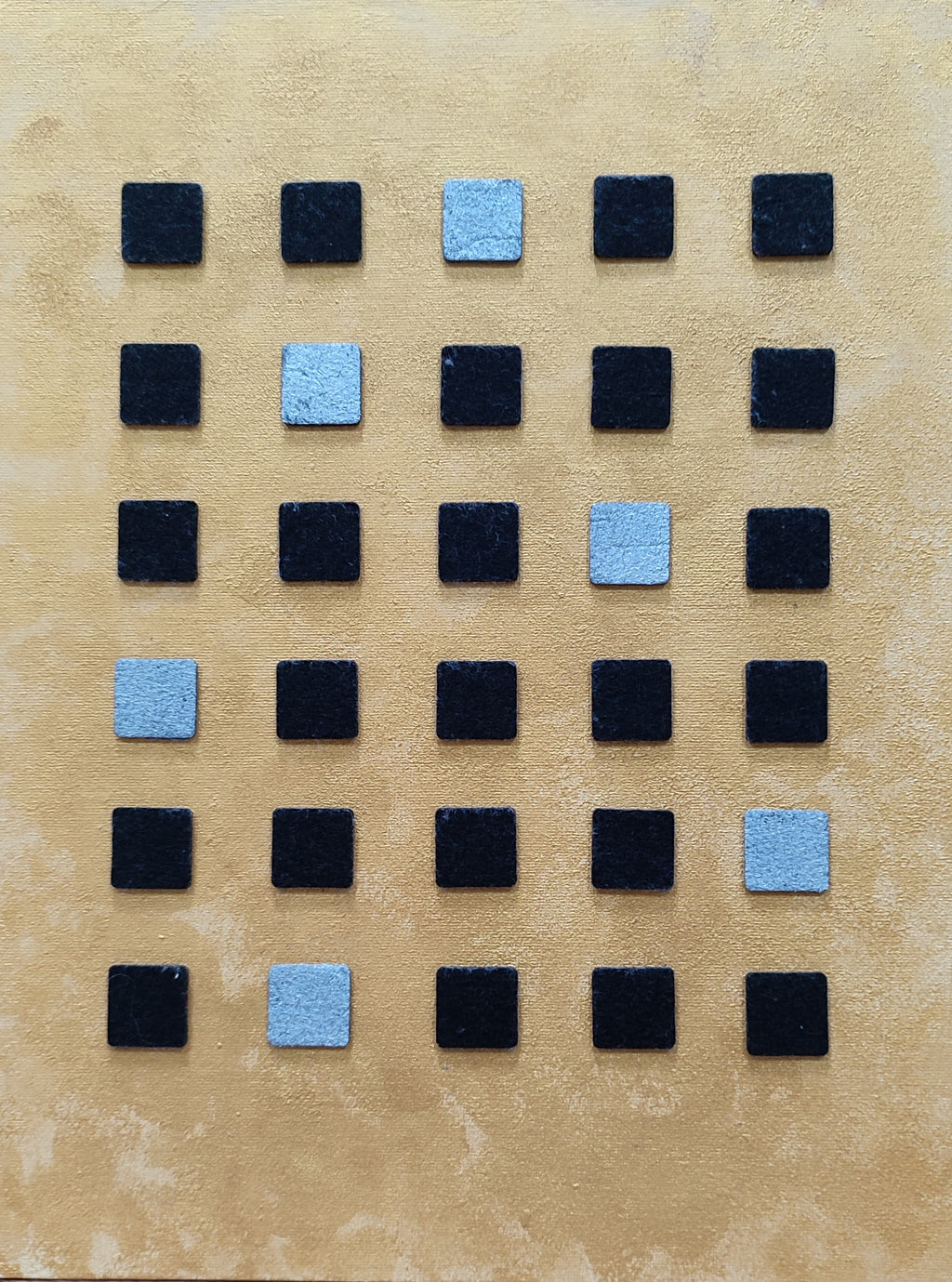 Pattern of black and blue square tiles on a beige background