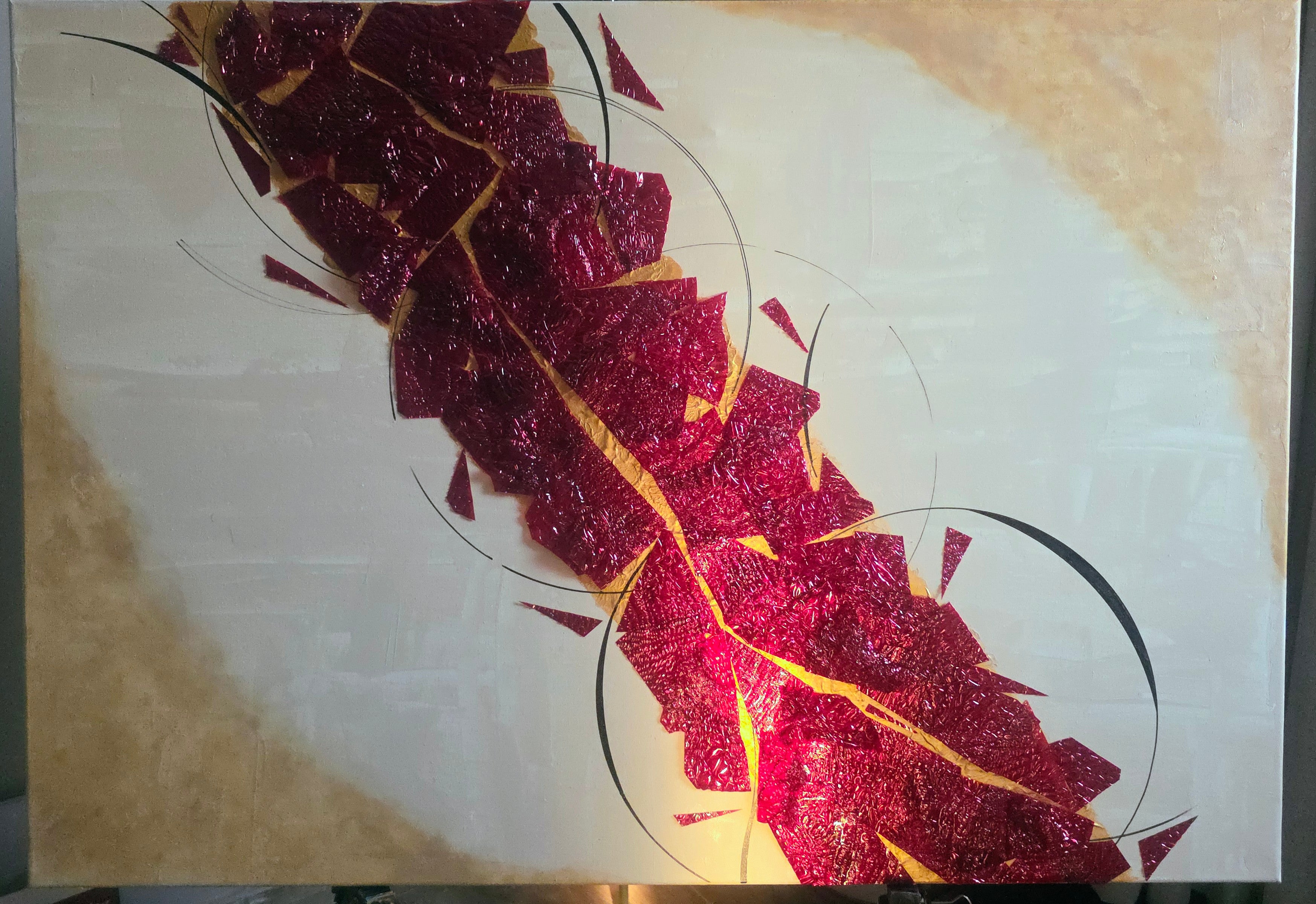 Abstract art piece with red and gold colors on a beige background