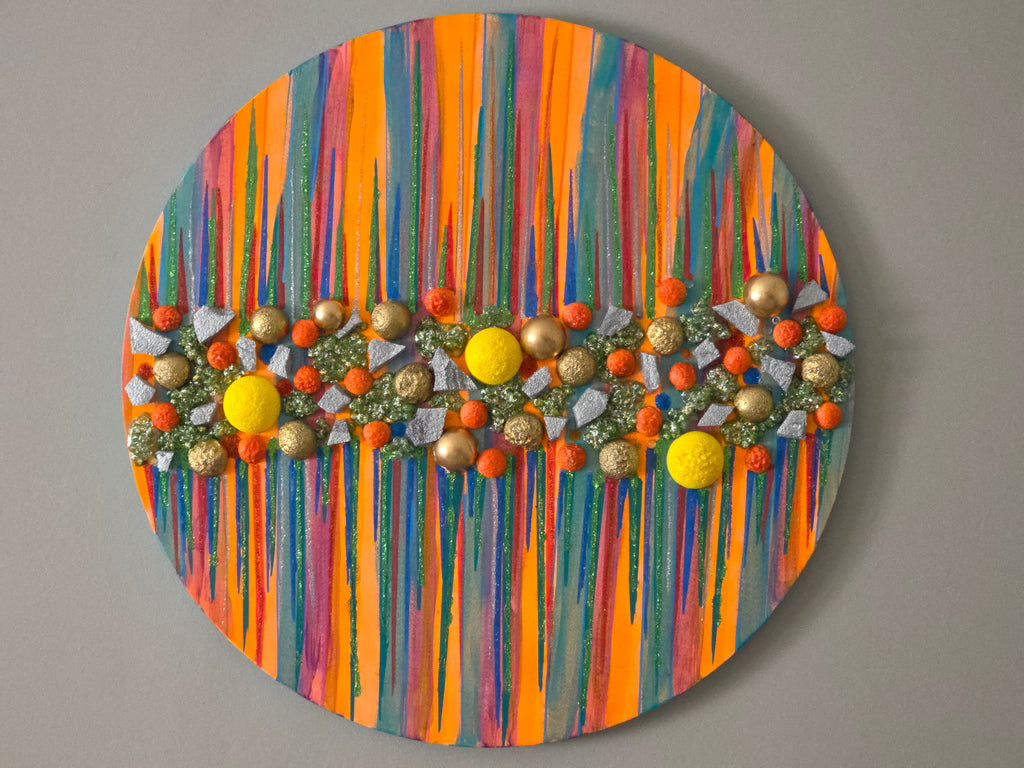 Vibrant modern abstract artwork displayed in a hotel lobby with warm lighting