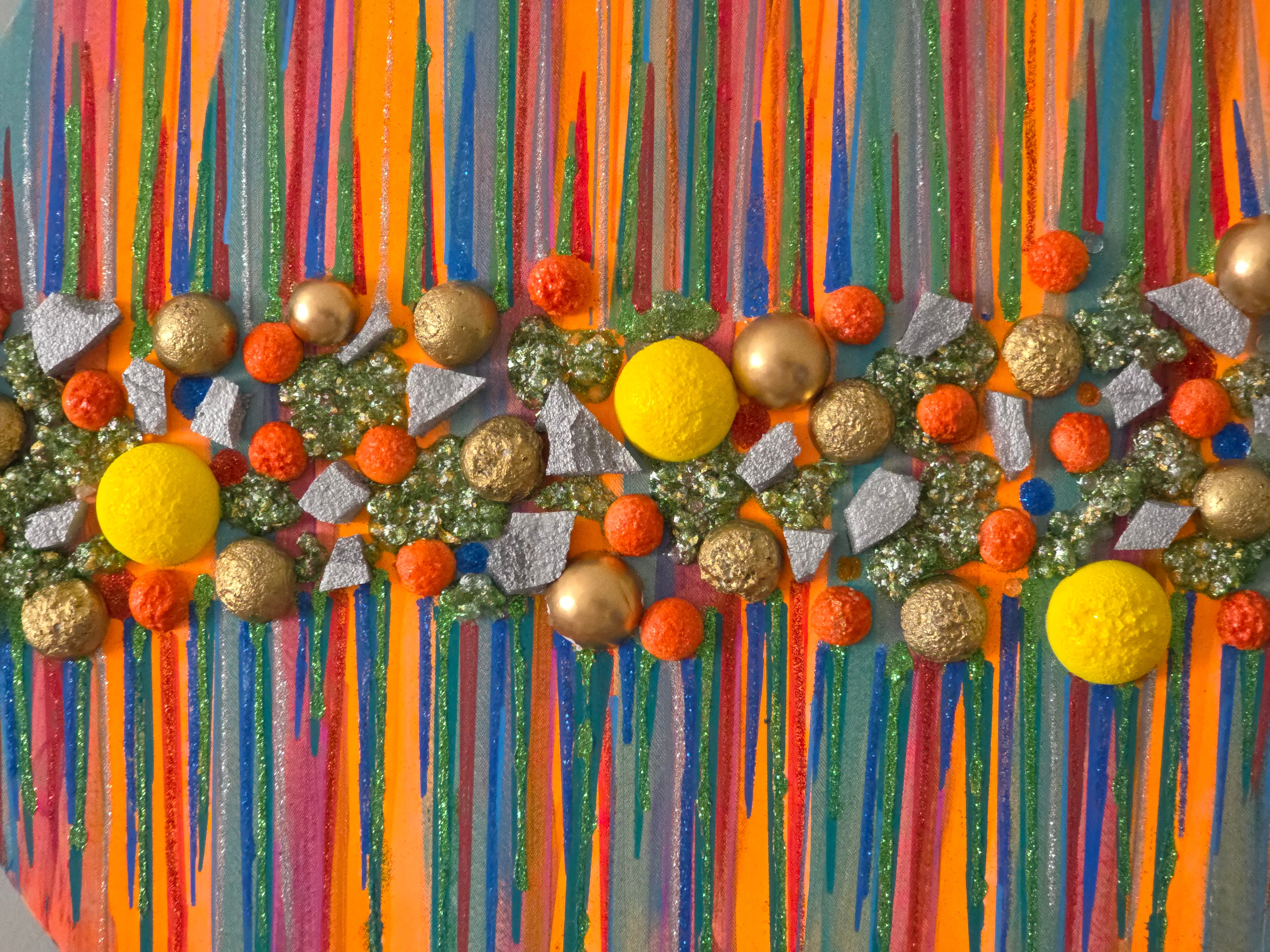 Decorative wall art with colorful vertical stripes and spherical ornaments.