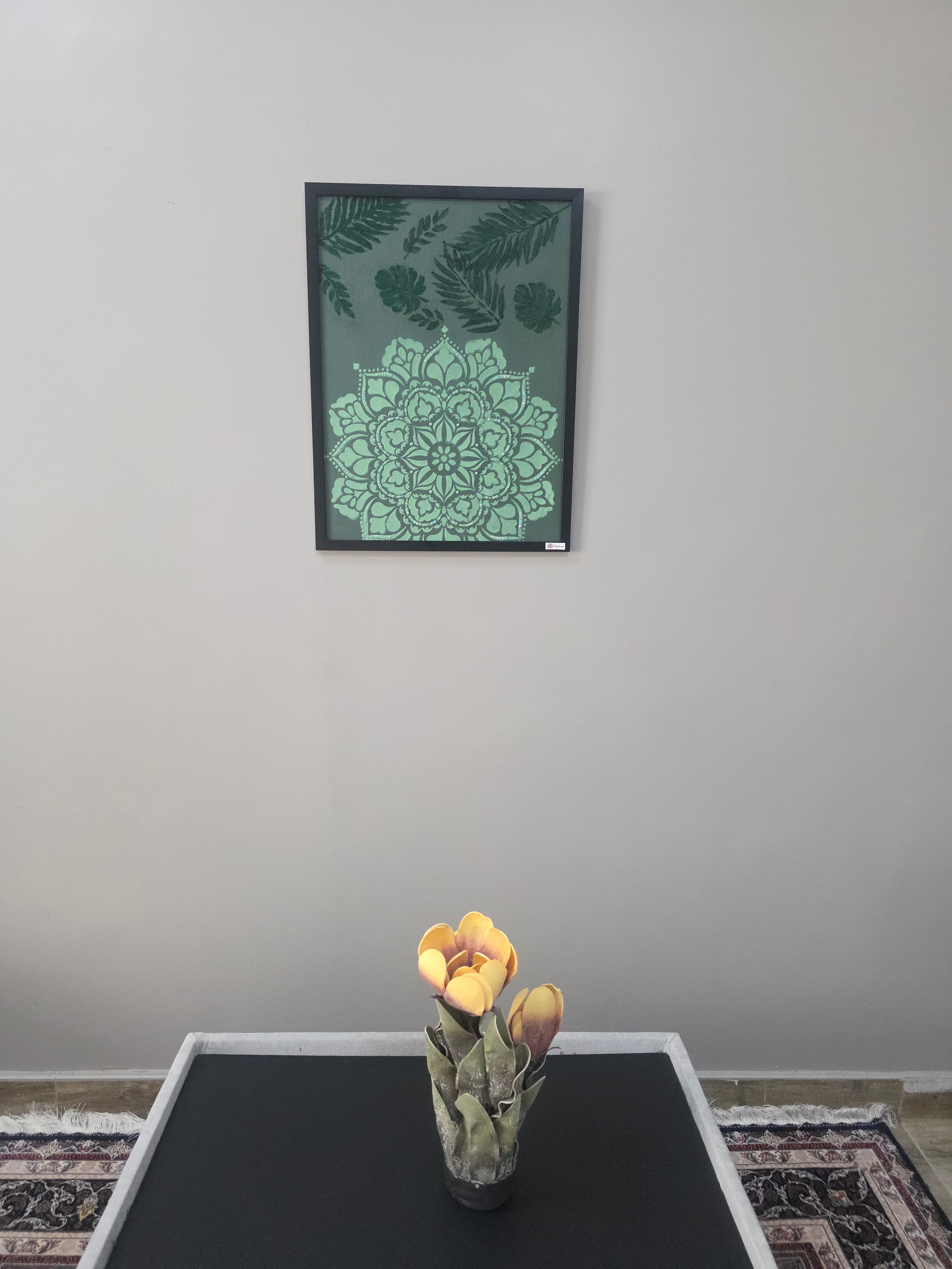 CatArts Decorative wall art with green mandala design on a gray wall next to a blackboard.