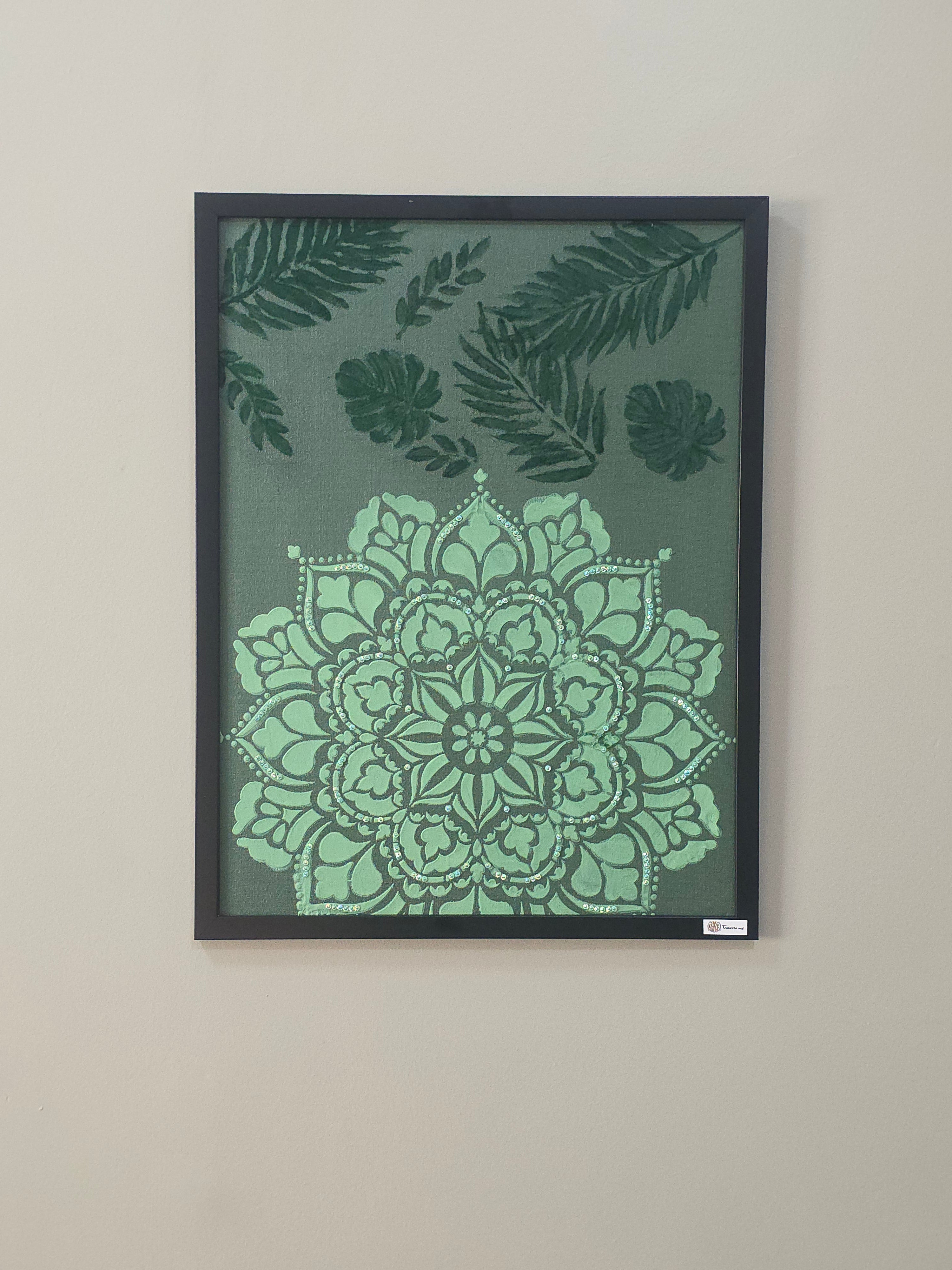 Framed artwork with green mandala and leaf patterns on a gray background