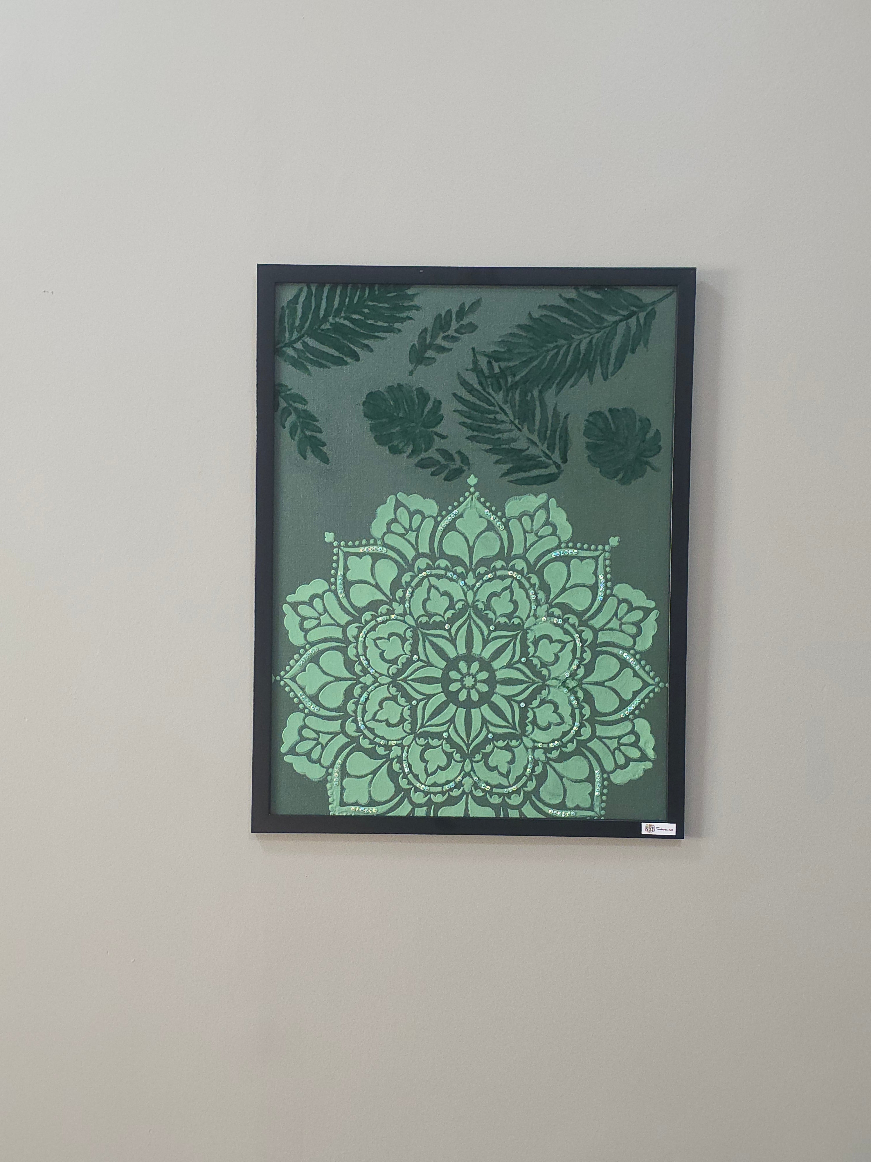 Framed artwork with green floral and mandala design on a gray background