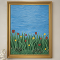 Framed artwork of grass with flowers against a blue sky on a wall.