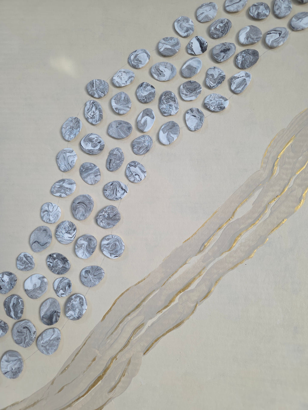 Silver coins arranged in a pattern on a beige surface