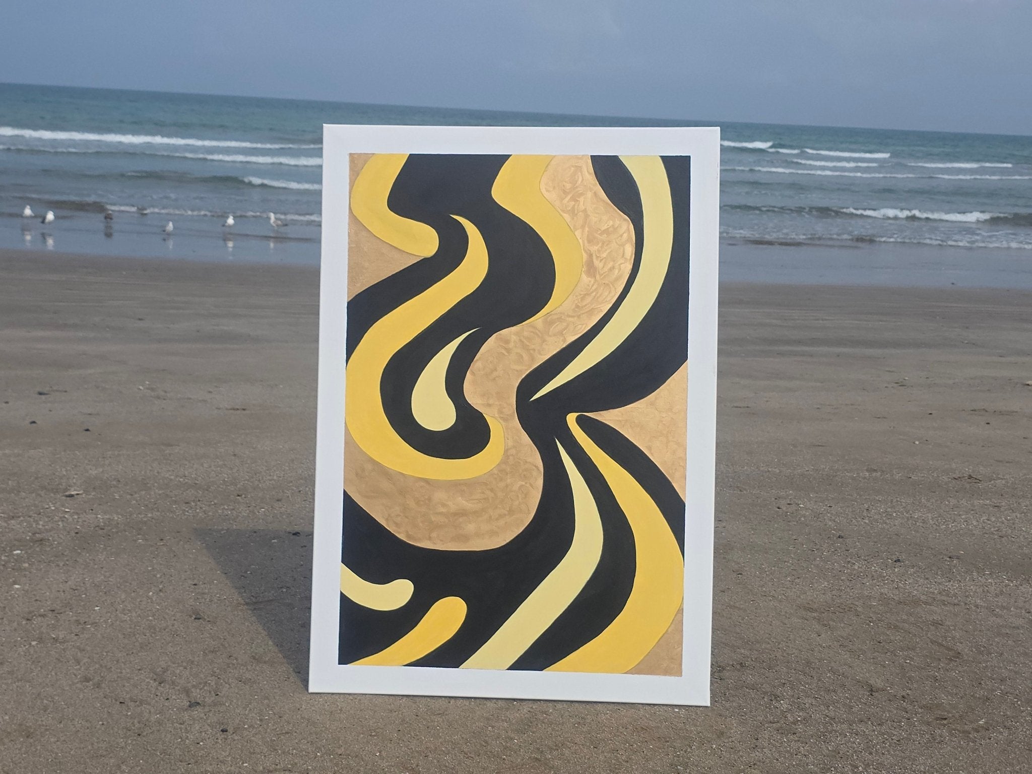 Original Gilded Tides painting shown outdoors on a beach to demonstrate the 70x100cm scale and natural color depth