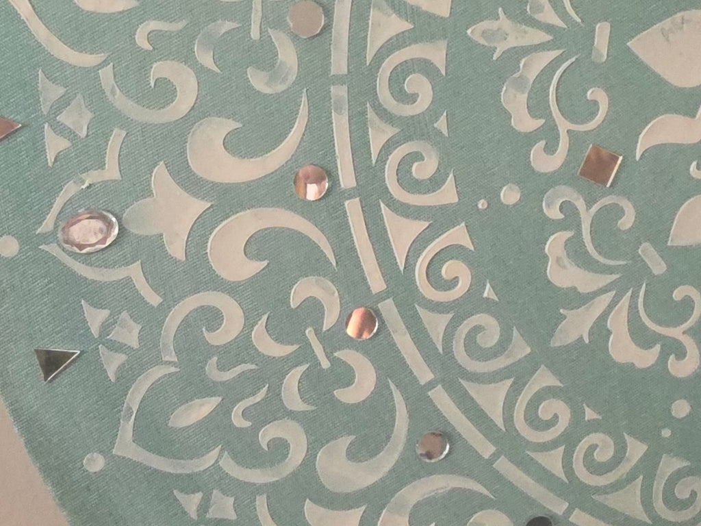 Detailed close-up of the raised texture and sparkling mirror fragments on the 'Mint Mandala Radiance' circular canvas