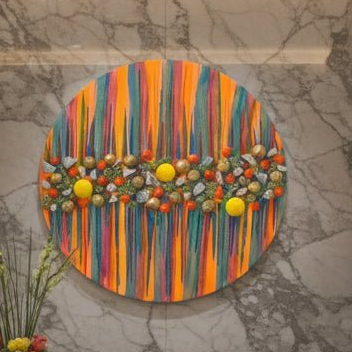 Colorful round tray with decorative elements on a marble surface